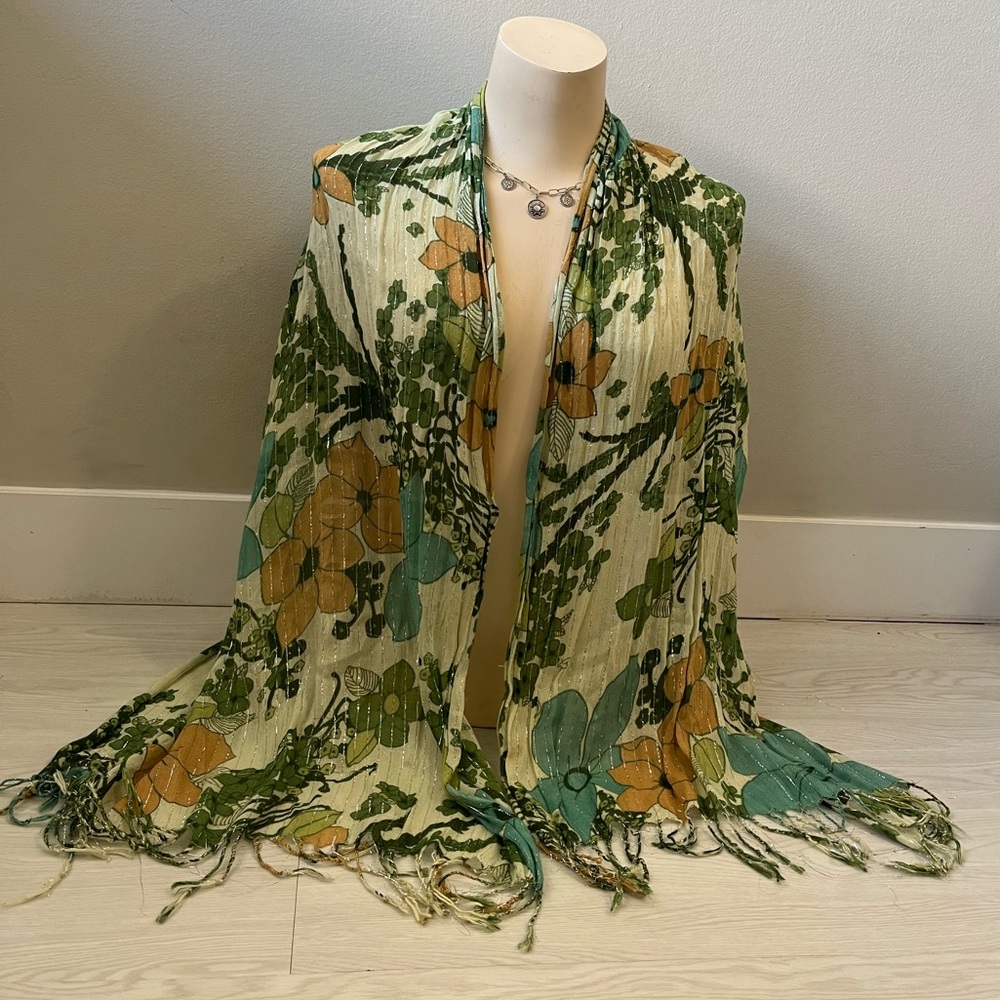 vintage-inspired scarf featuring a green and orange floral pattern with fringes